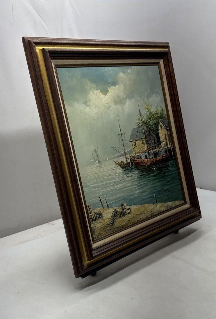 Harbor scene painting of fishing boats at docks in dark wood frame with gold-tone inner border, view 3