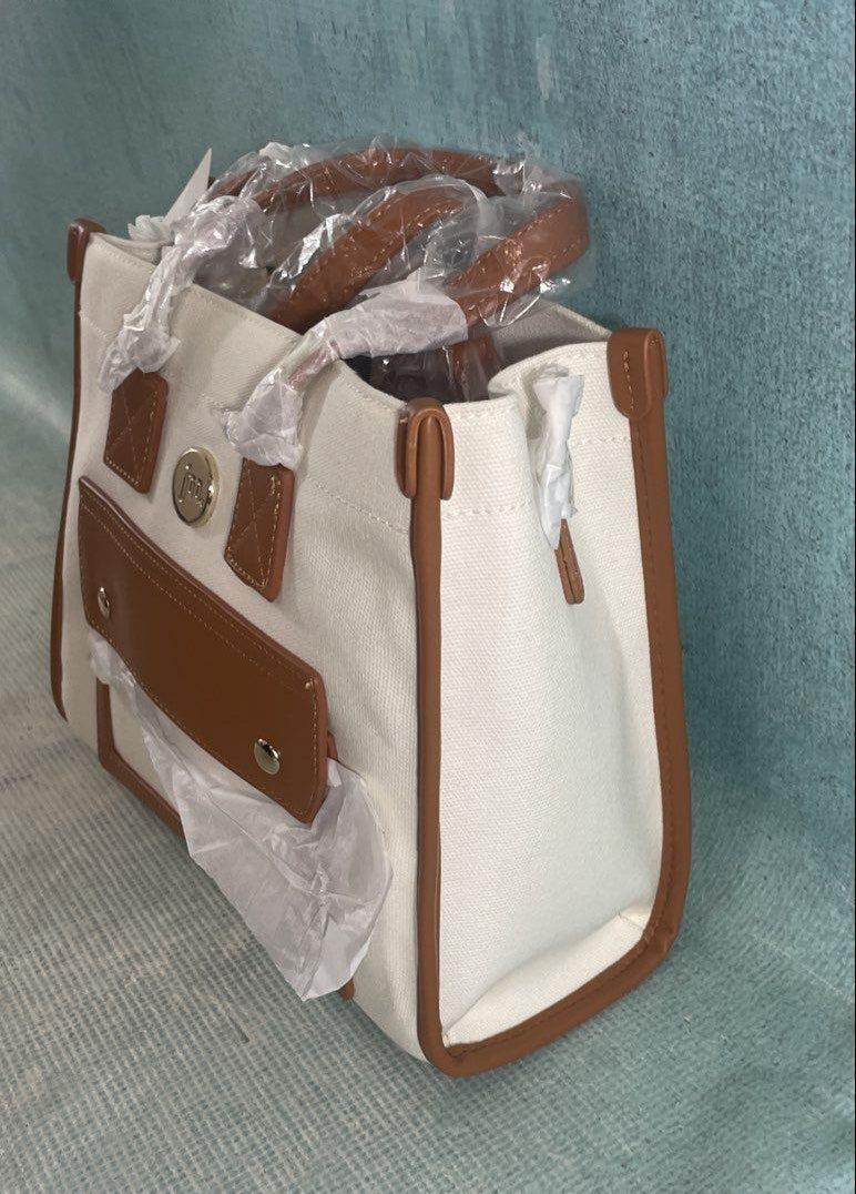 Jessica Moore cream canvas satchel with tan trim, front cargo pocket and gray dust bag, view 6