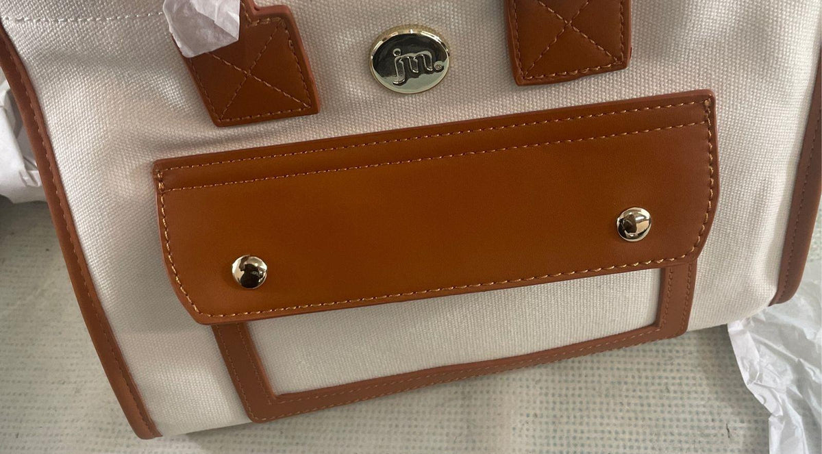 Jessica Moore cream canvas satchel with tan trim, front cargo pocket and gray dust bag, view 12