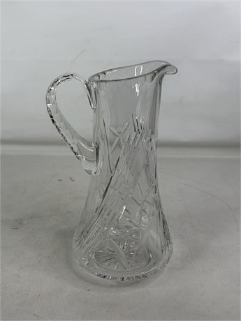 Tall clear cut glass pitcher with floral and leaf decoration and textured handle, view 3