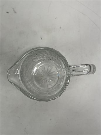 Tall clear cut glass pitcher with floral and leaf decoration and textured handle, view 6