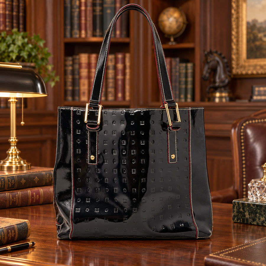 Arcadia black logo-embossed patent leather shoulder tote with red edges and gold-tone buckles