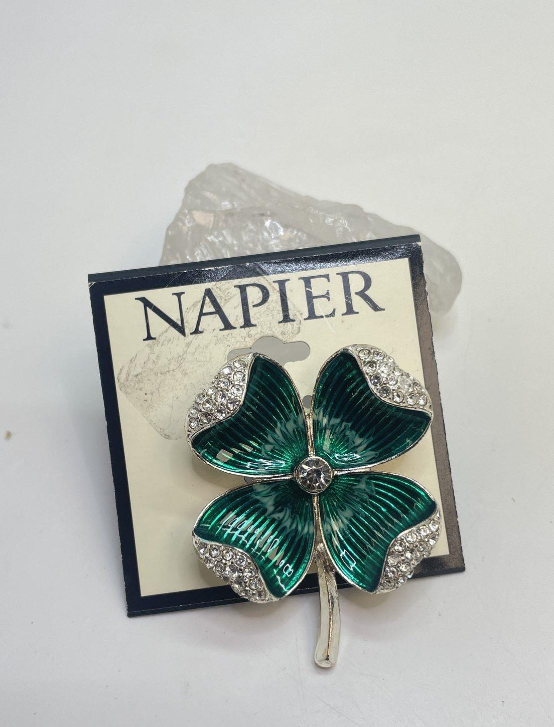 Silver-tone four-leaf clover brooch with green enamel leaves and clear rhinestones on display card, view 3