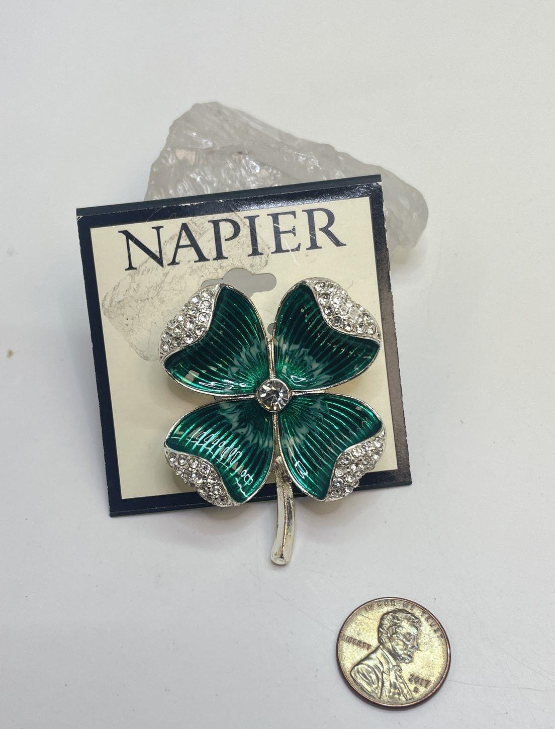 Silver-tone four-leaf clover brooch with green enamel leaves and clear rhinestones on display card, view 4