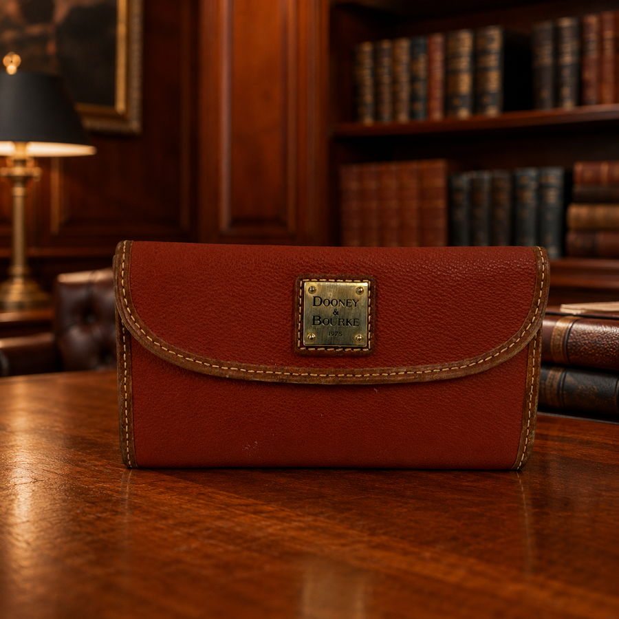 Dooney and Bourke red-brown pebbled envelope wallet with gold-tone 1975 plaque