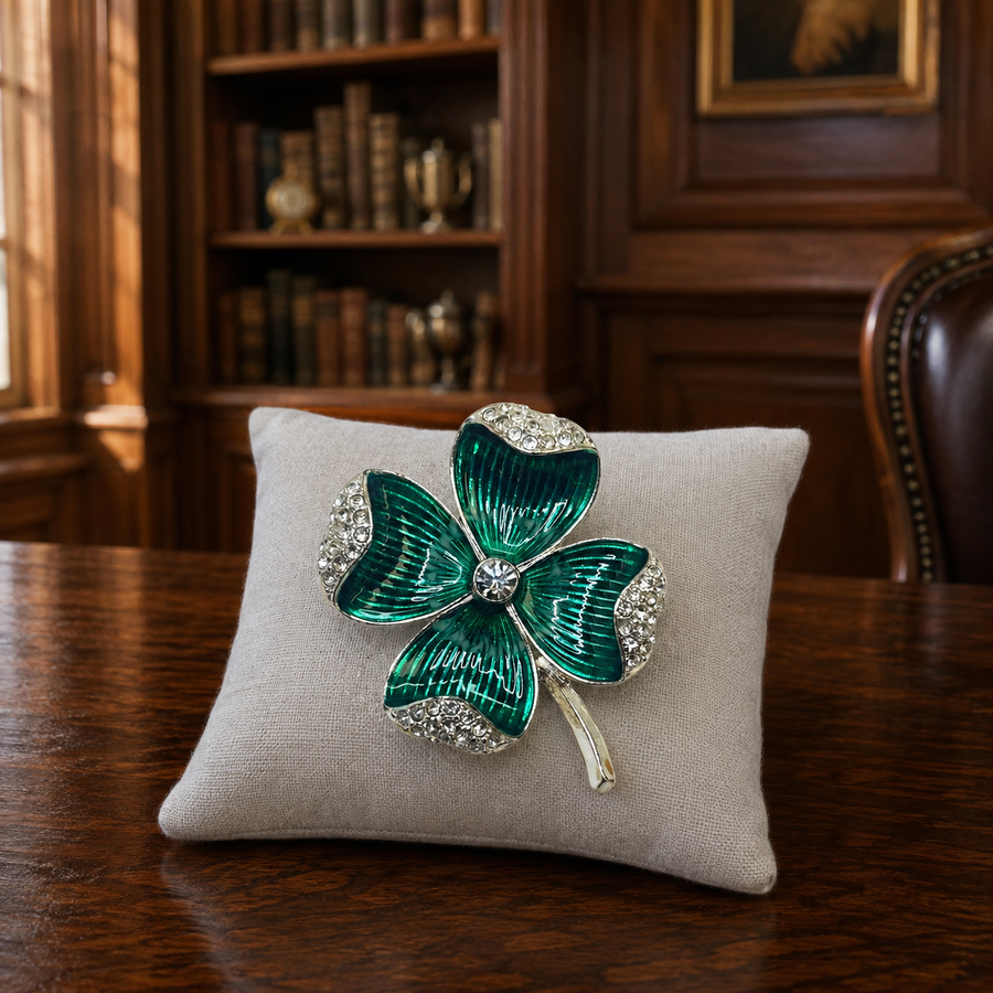 Silver-tone clover brooch with folded green rhinestone leaves