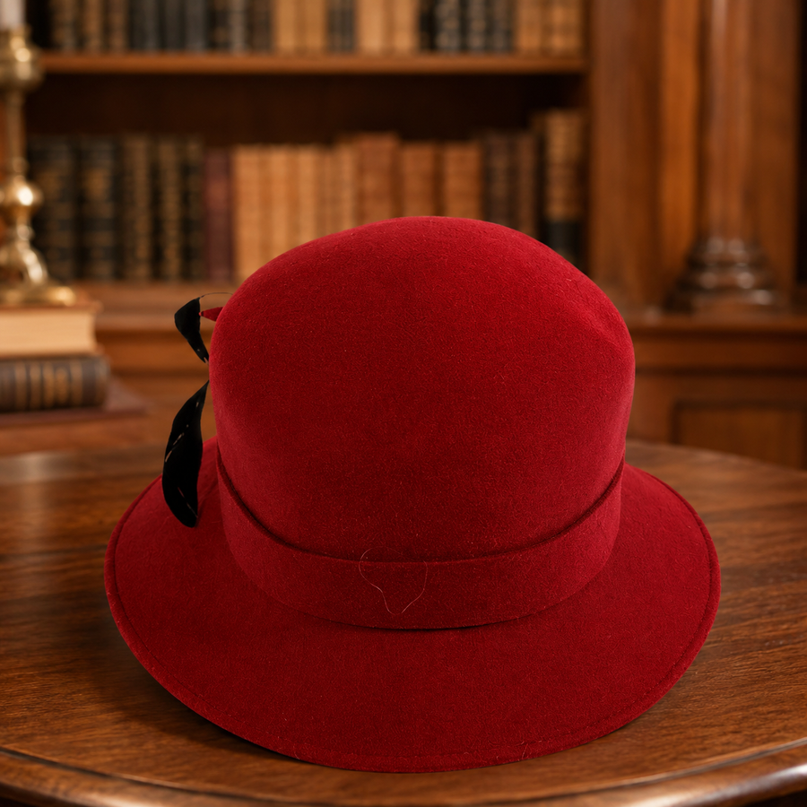 Red wool felt cloche hat with black ribbon and feather trim