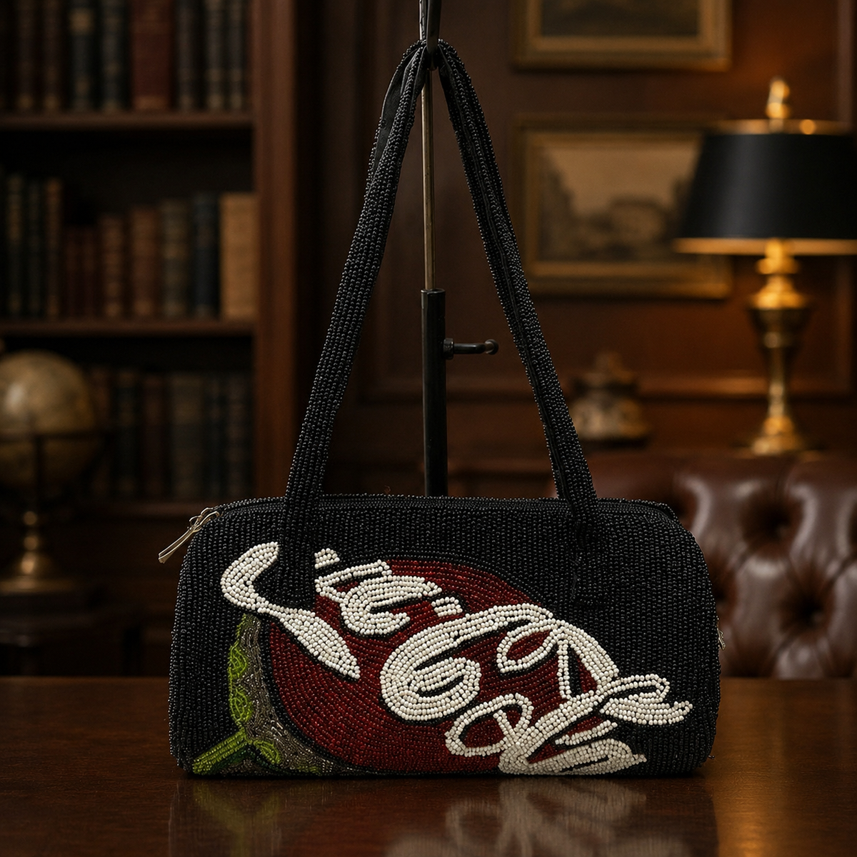 Black beaded cylindrical shoulder bag with red, white and green Coca-Cola script motif
