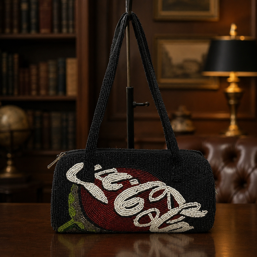 Black beaded cylindrical shoulder bag with red, white and green Coca-Cola script motif