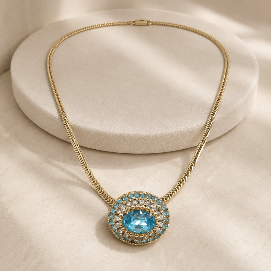 Signed Coro gold-tone choker necklace with blue and clear rhinestone medallion