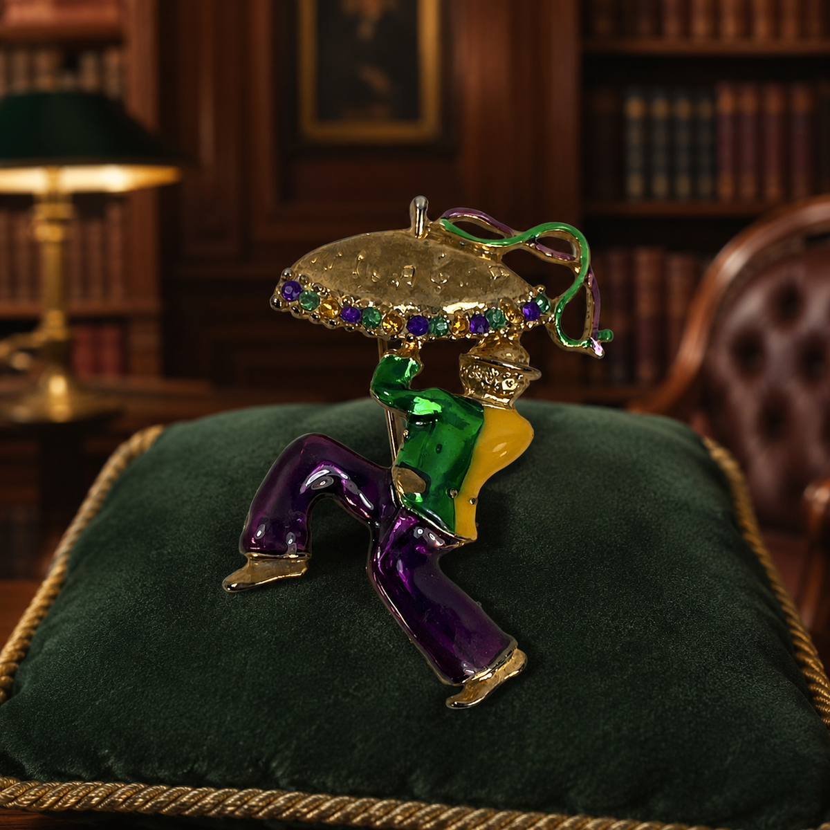Gold-tone enamel brooch of a jester holding a jeweled parasol