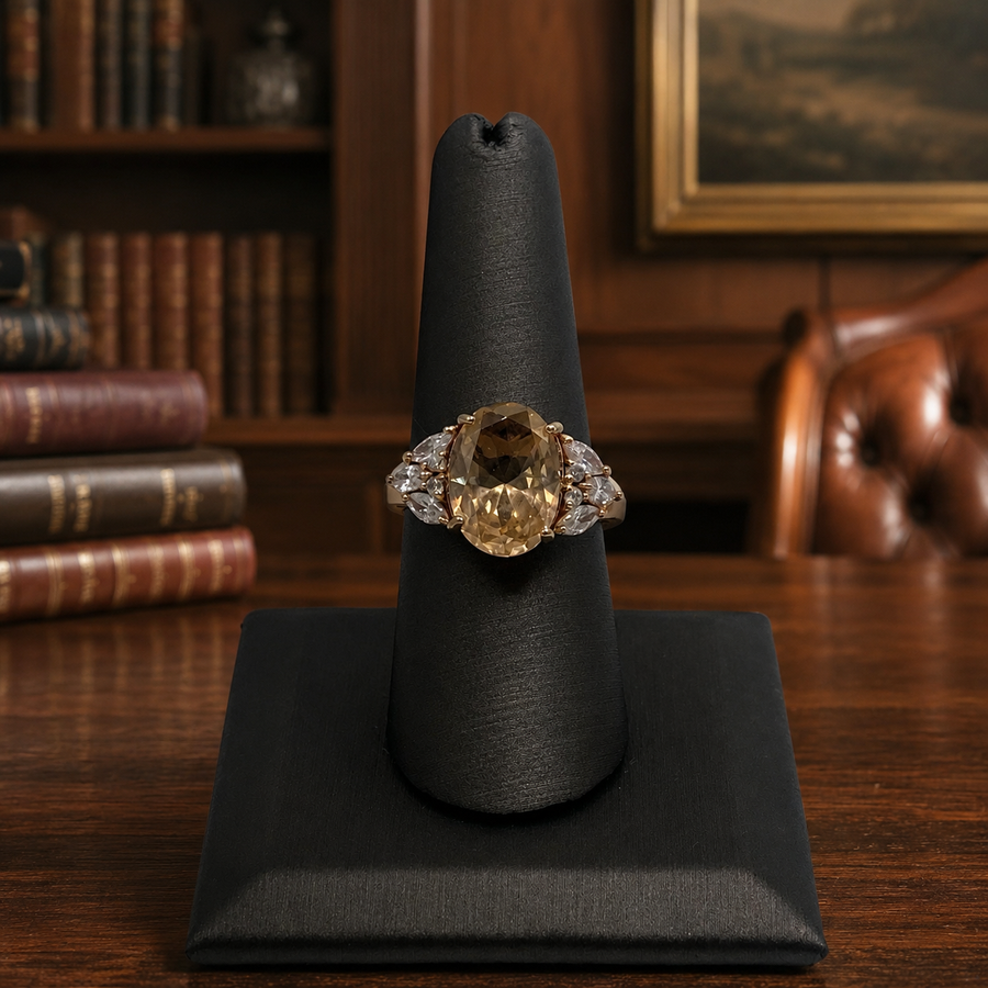 Signed BBJ gold-tone cocktail ring with oval champagne center stone and clear cluster