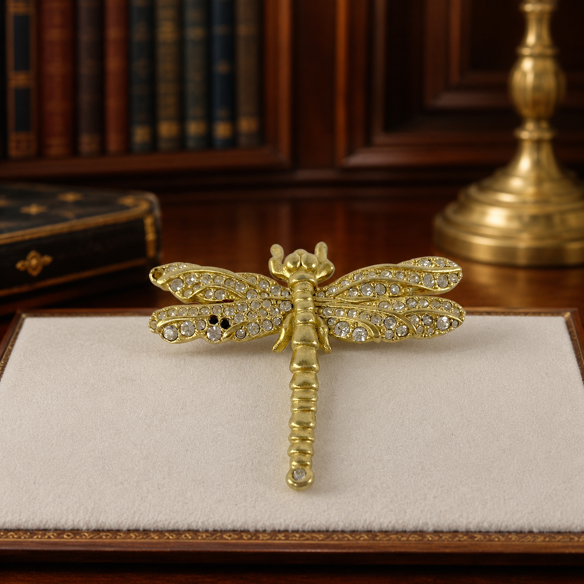 Gold-tone dragonfly brooch with clear crystals, several crystals missing from the wings