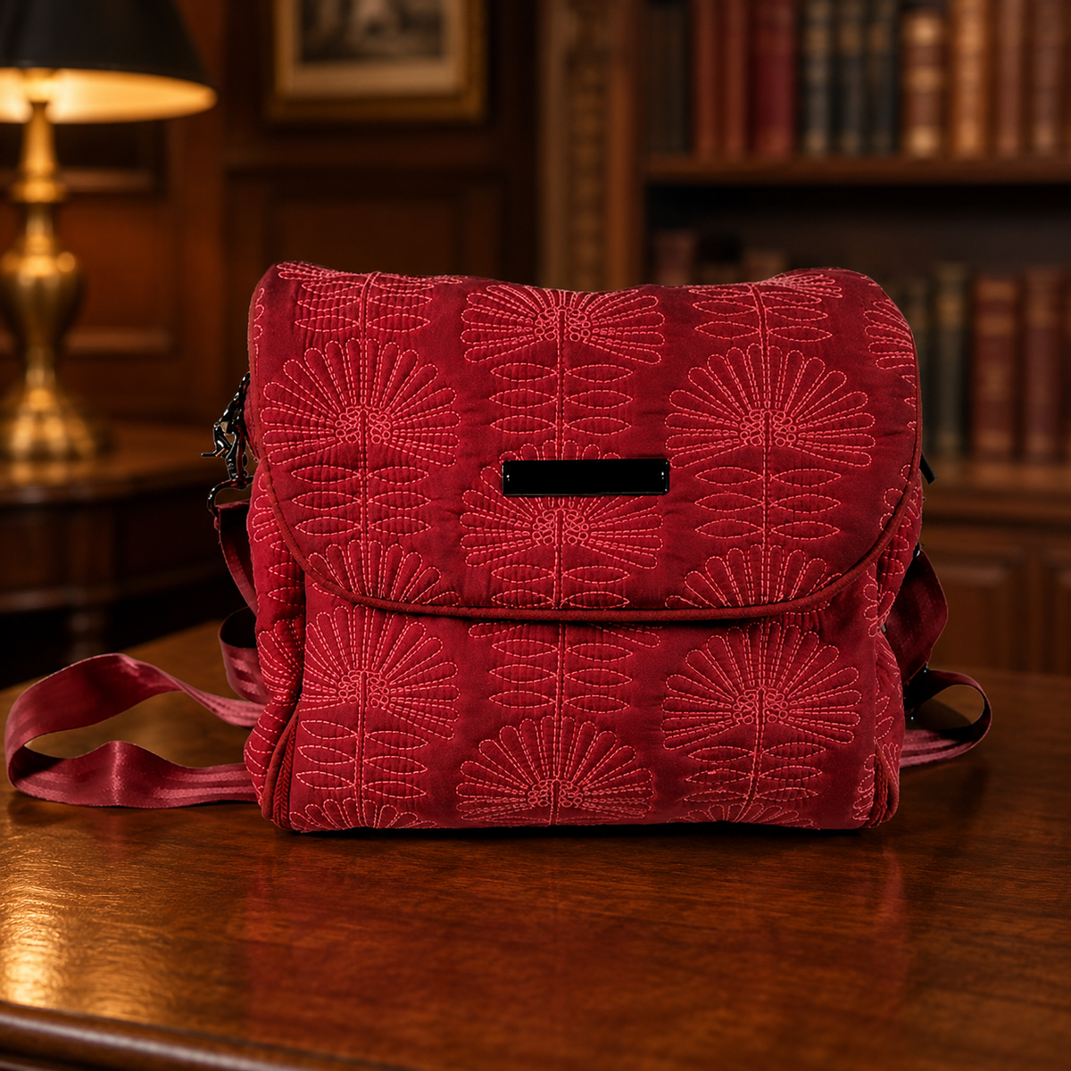 Pink quilted floral diaper bag with foldover flap and shoulder strap