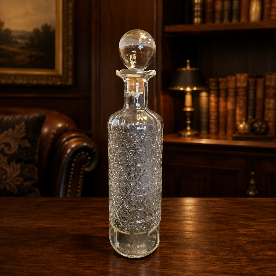 Tall clear glass Stremmel decanter with molded geometric pattern and round ball stopper