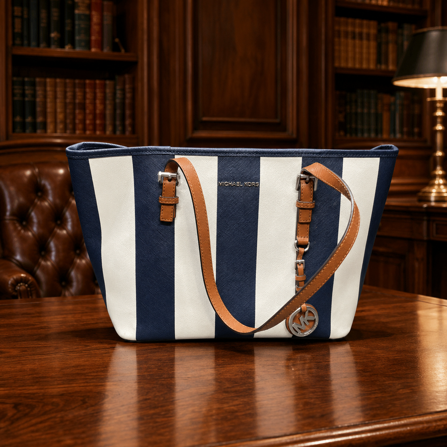 Blue and white striped canvas travel tote with tan leather trim and shoulder straps