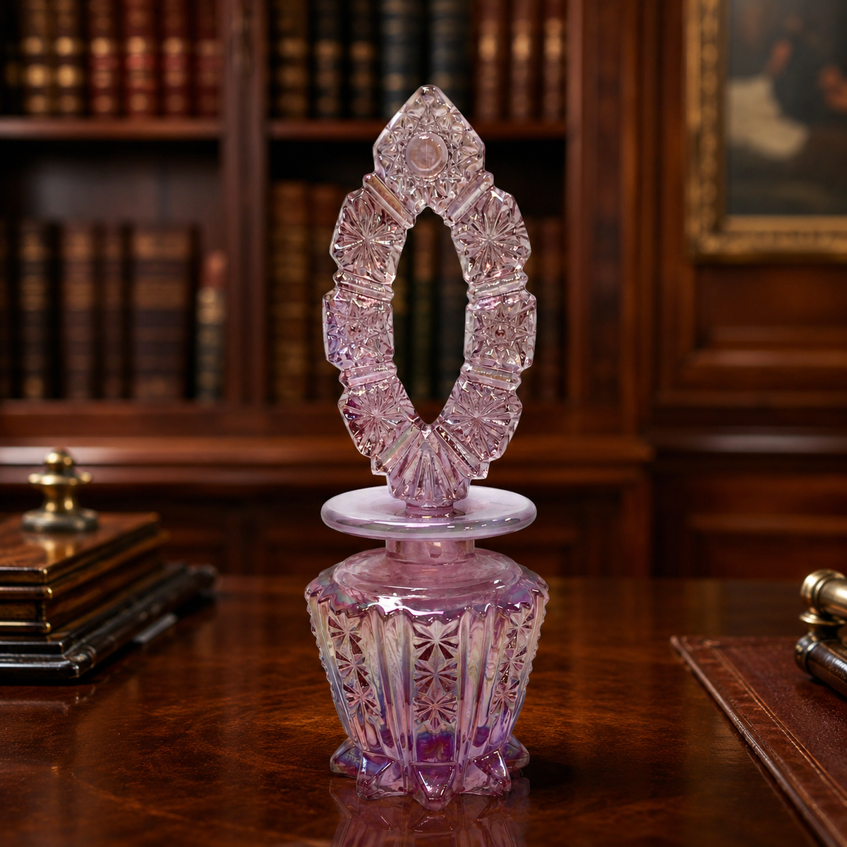 Pink iridescent carnival glass footed decanter with starburst panels and pierced oval stopper