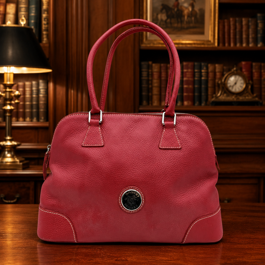Dooney and Bourke rose pink pebbled leather domed satchel with rolled handles and shoulder strap