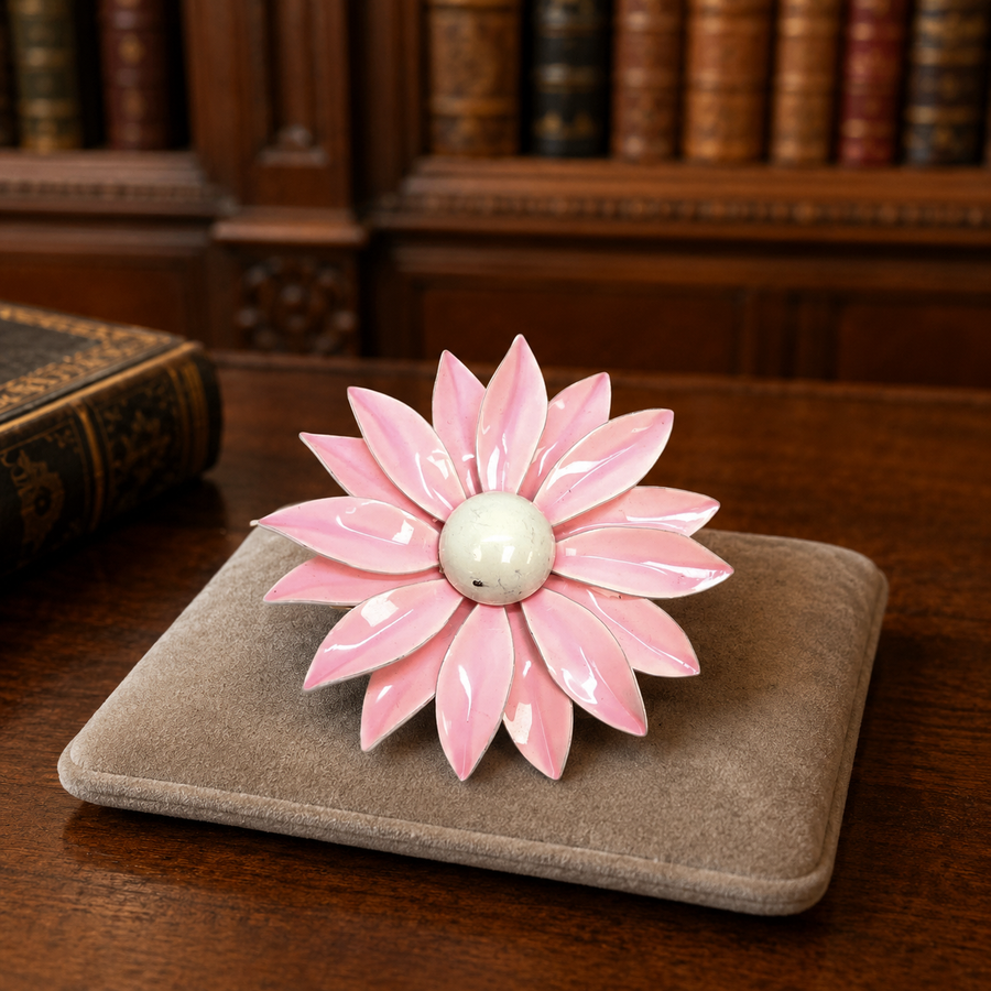 Gold-tone layered daisy brooch with soft pink enamel petals and cream cabochon center