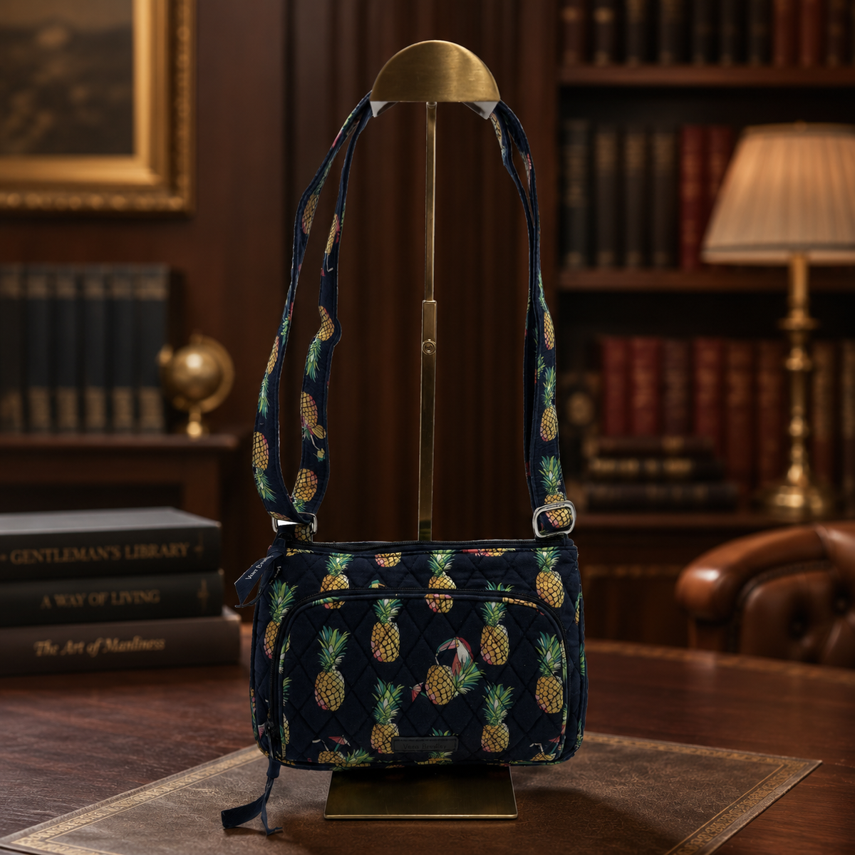 Navy quilted fabric shoulder bag with allover pineapple print and front zip pocket