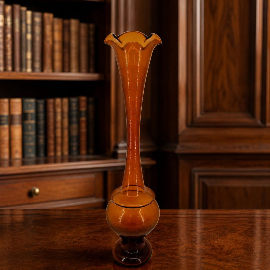 Kreiss amber glass bud vase with flared rim, slender neck and dark footed base