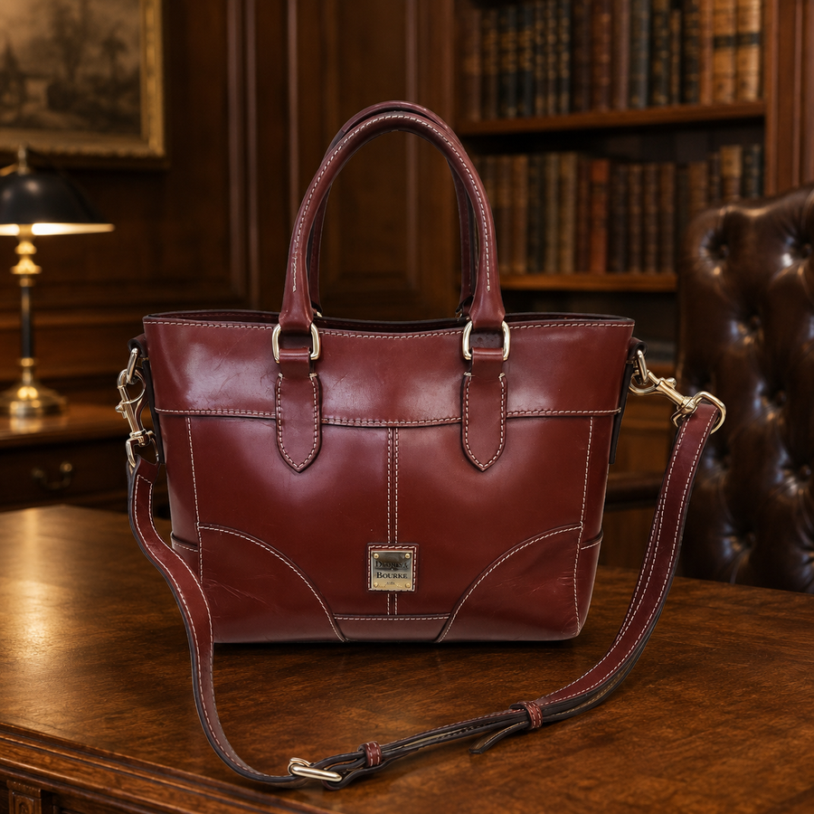 Dooney & Bourke reddish brown smooth leather satchel with rolled handles and crossbody strap