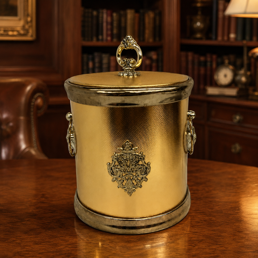 Round gold-tone ice bucket with textured sides, side handles and decorative lid