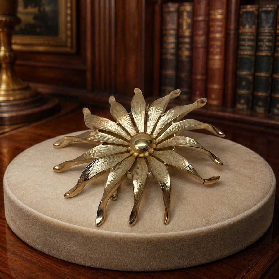 Crown Trifari gold-tone flower brooch with pearl-style center
