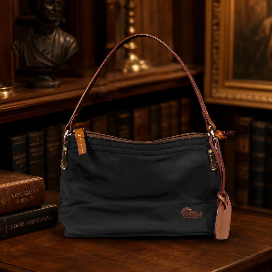 Dooney and Bourke black nylon shoulder bag with tan leather trim and duck logo patch
