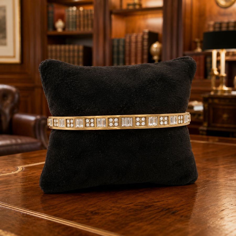 Gold-tone bangle bracelet with geometric crystal accents