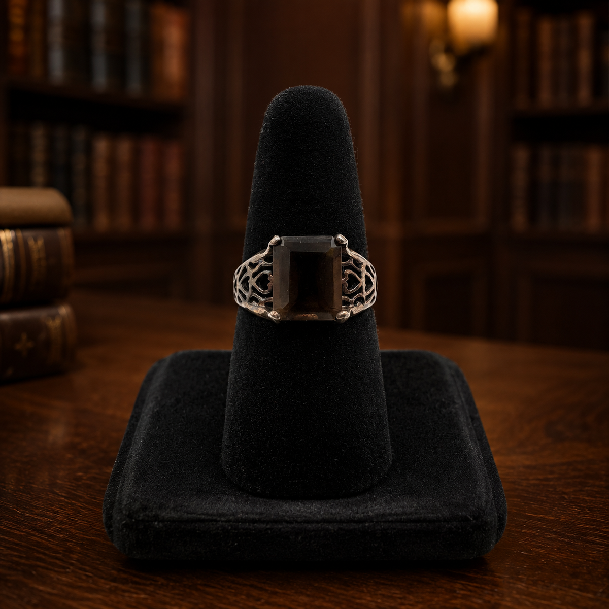 Silver ring with rectangular smoky brown stone in four prongs and openwork filigree shoulders