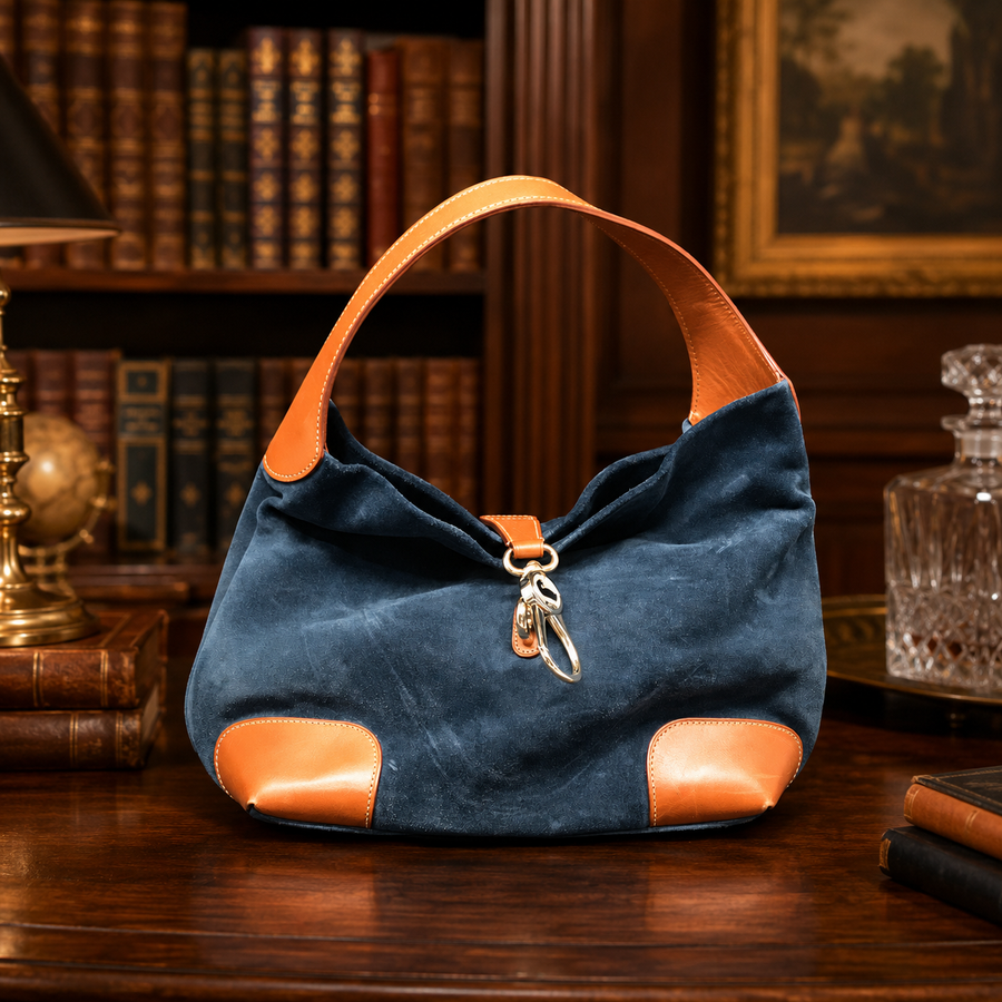 Dooney and Bourke navy blue suede shoulder purse with cognac brown leather trim and duck logo charm