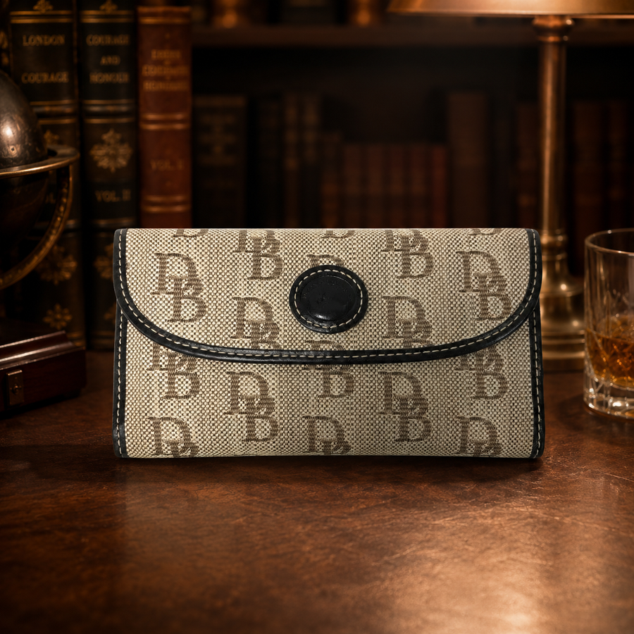 Beige monogram wallet with dark trim and rounded snap flap