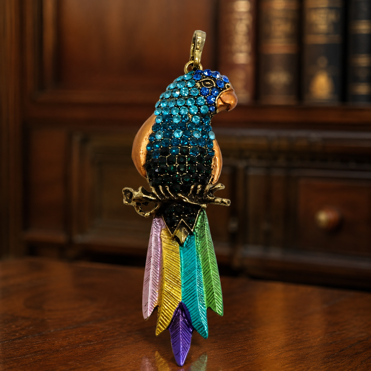 Gold-tone tropical parrot pendant with blue and green rhinestones, enamel and iridescent dangles