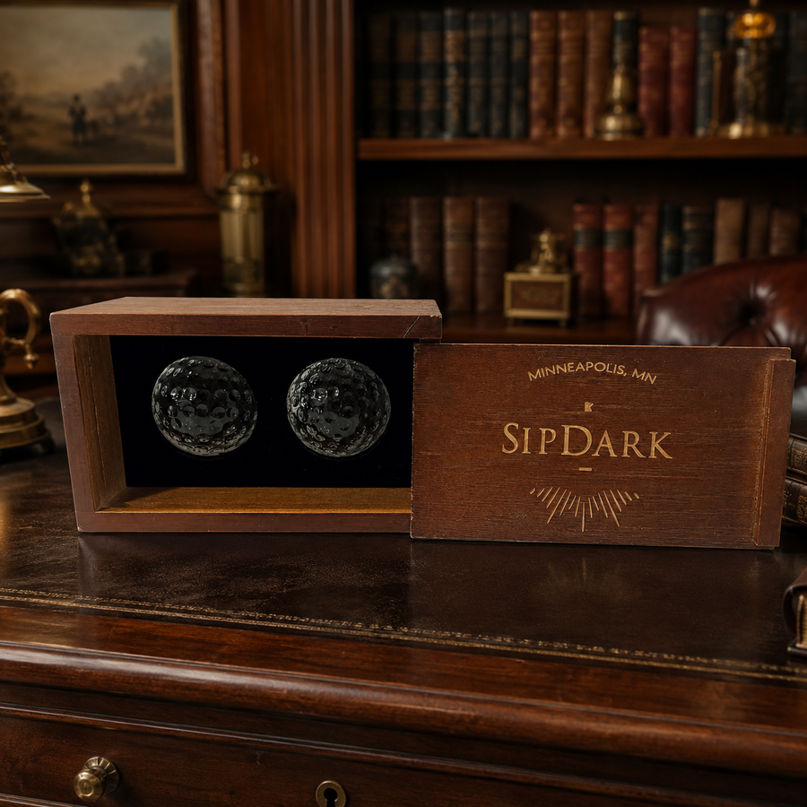 SipDark two golf ball style glass whiskey chillers in a sliding-lid wooden box