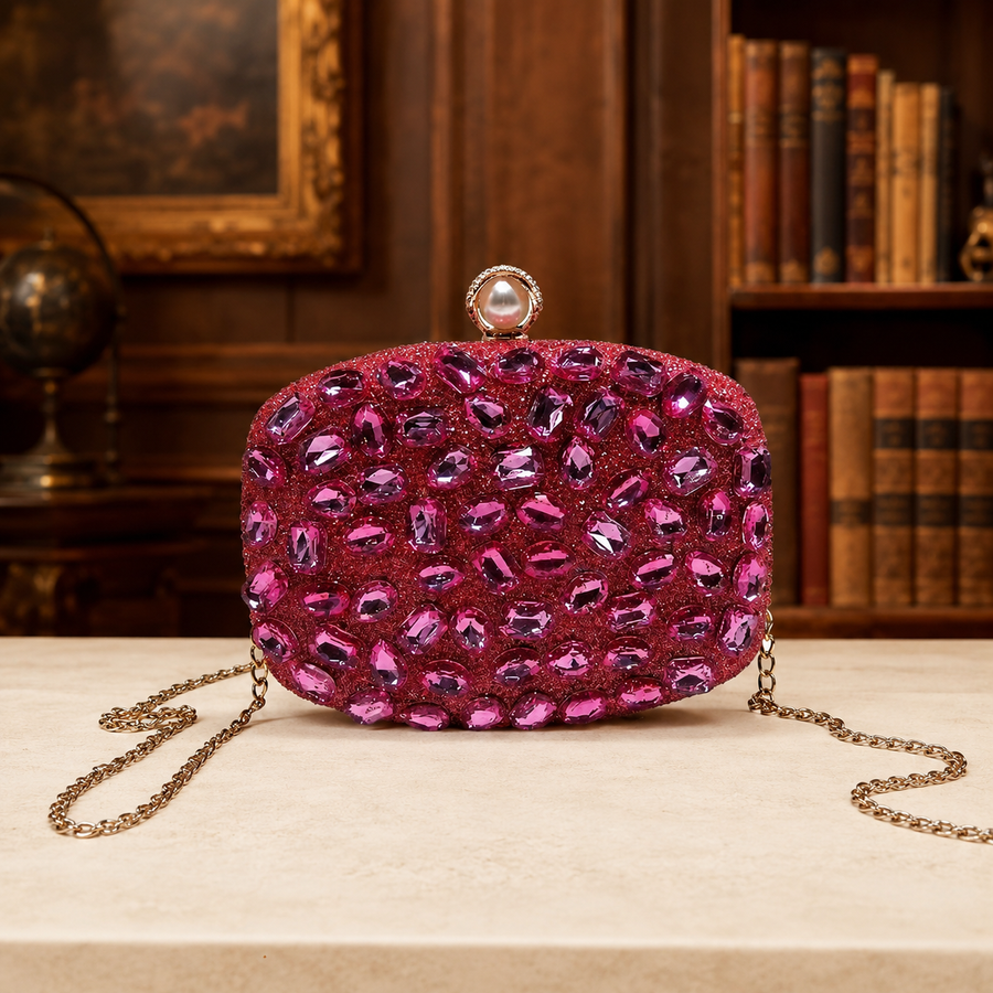 Bright pink hard-case clutch with faceted studs, push clasp and chain strap