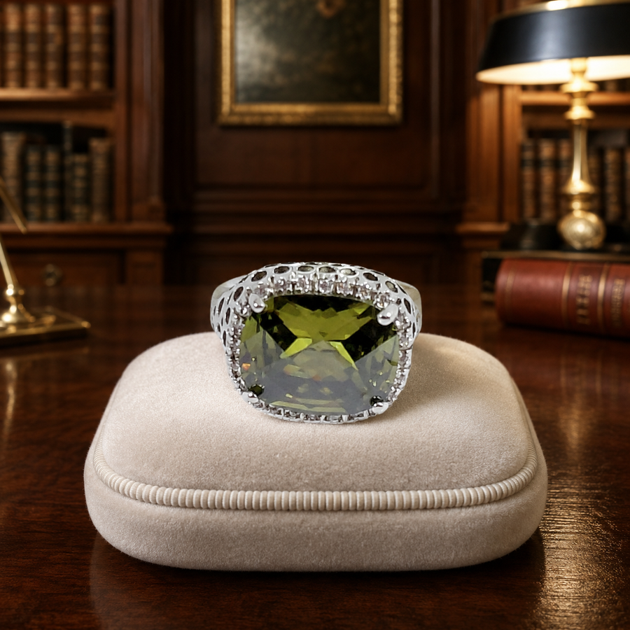 Silver-tone halo ring with olive-green cushion-cut center stone and clear stone halo