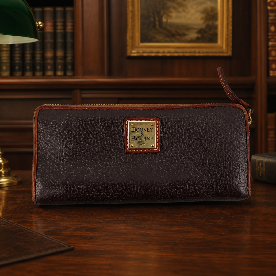 Dooney & Bourke brown pebbled leather zip around wallet with tan trim and red interior
