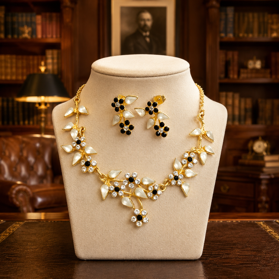 Gold-tone Yoni Z necklace and post earrings with black and white flowers and clear accents