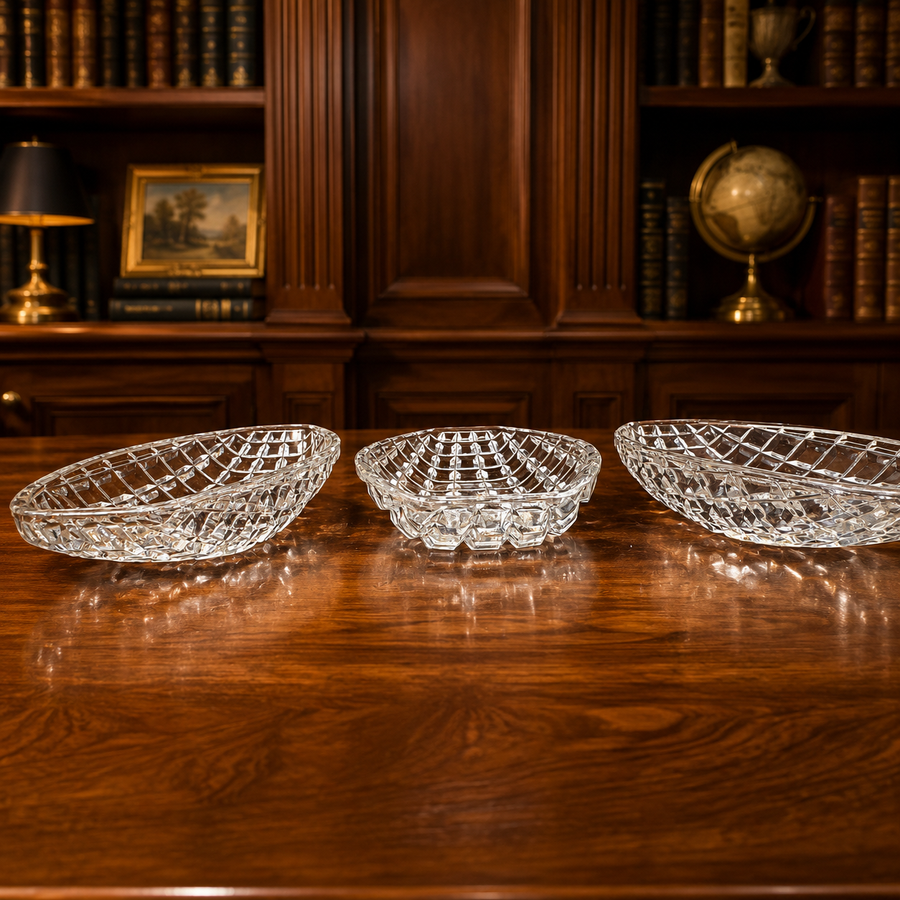 Three clear oval glass serving trays with raised diamond-grid pattern