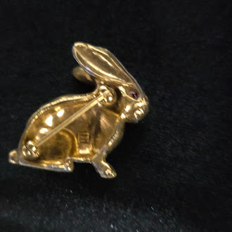 Gold-tone rabbit brooch in profile with textured fur and red eye, view 2