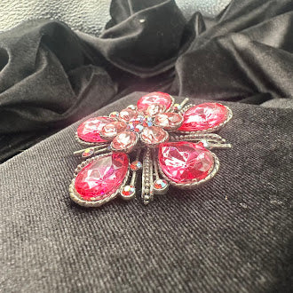 Silver-tone flower brooch with pink teardrop crystal petals and radiating bars, view 4