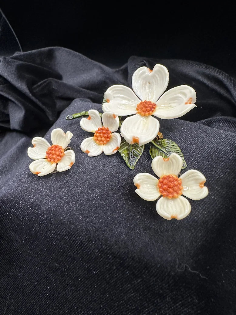 White dogwood flower brooch and clip earrings with orange bead centers and green enamel leaves, view 2