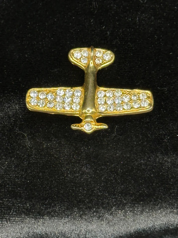 Gold-tone stylized airplane brooch with clear rhinestone accents on the wings, view 5