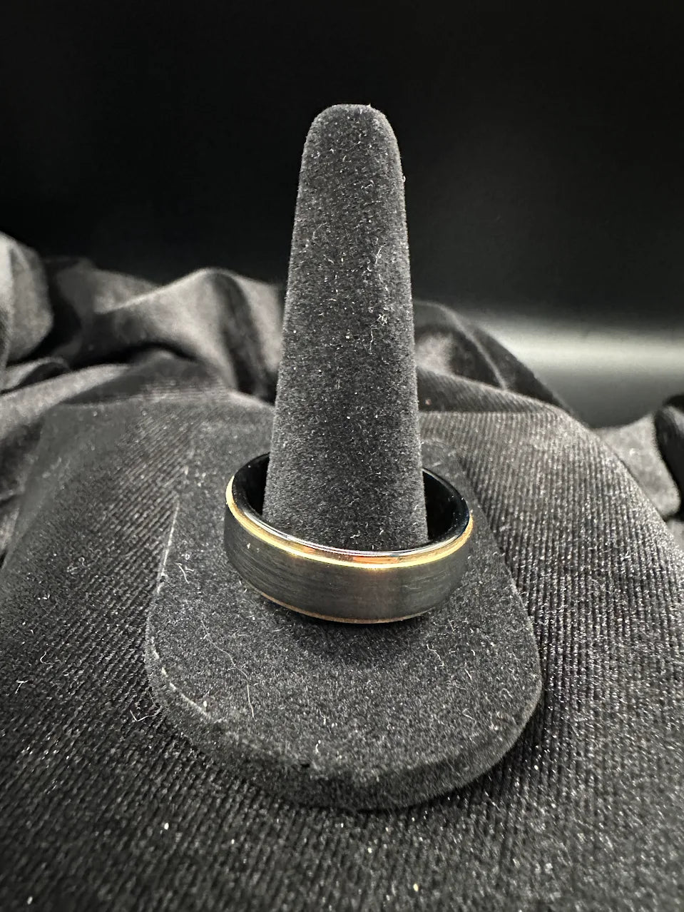 Men's wedding band with brushed black exterior and gold-tone interior, listed as tungsten, view 2