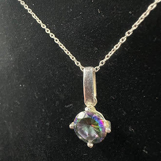 Round rainbow-hued faceted stone solitaire pendant in a four-prong setting on a fine chain, view 2