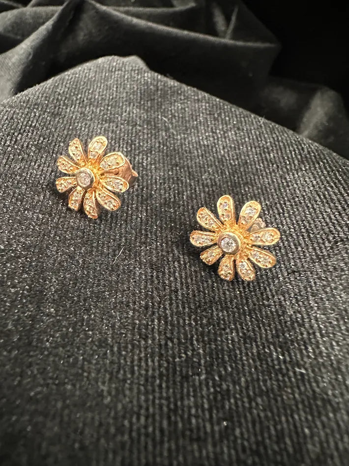Petite gold-tone flower stud earrings with clear crystal petals and larger center crystal, view 2