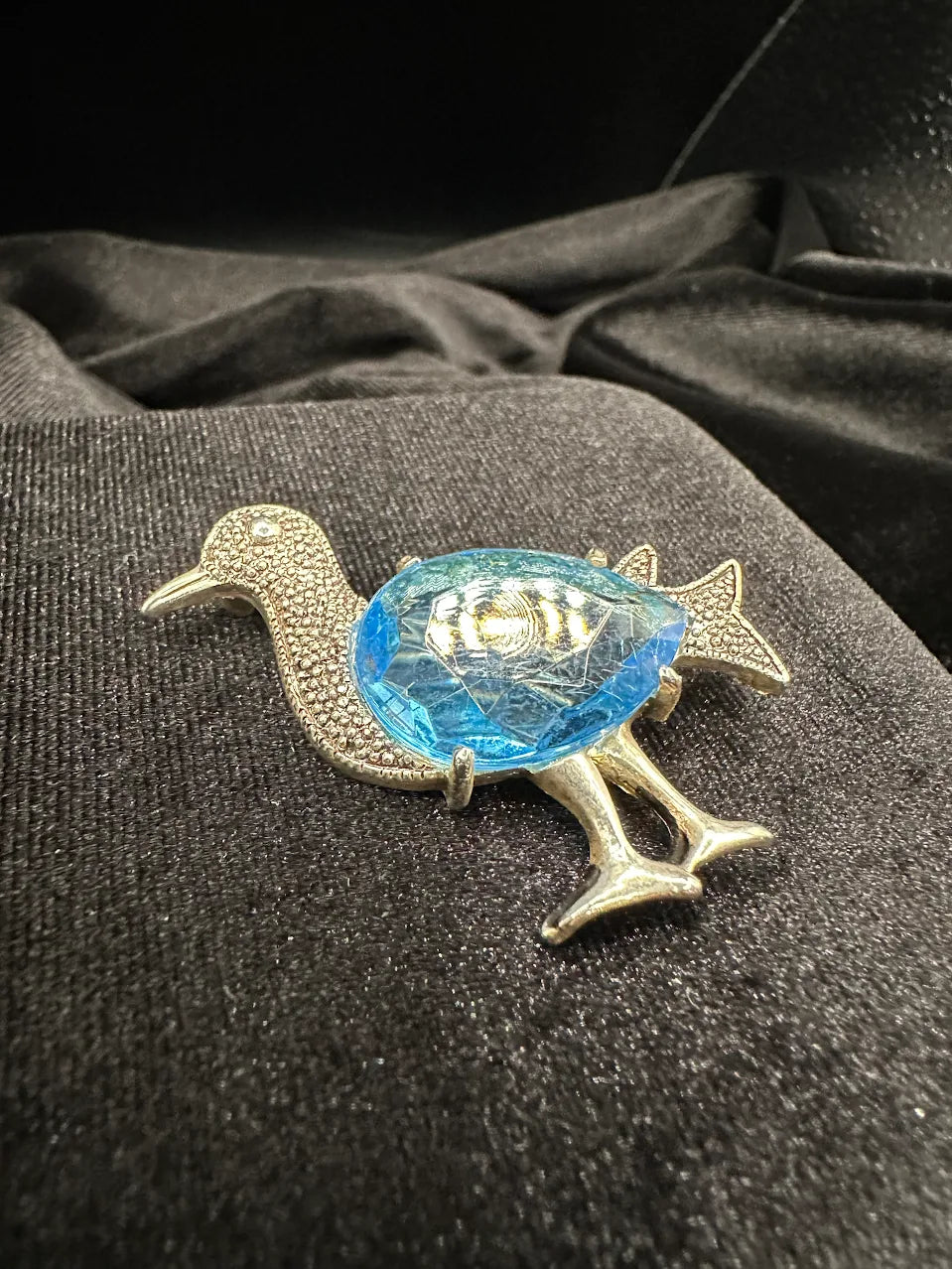 Silver-tone duck brooch with large faceted light blue crystal body, view 4