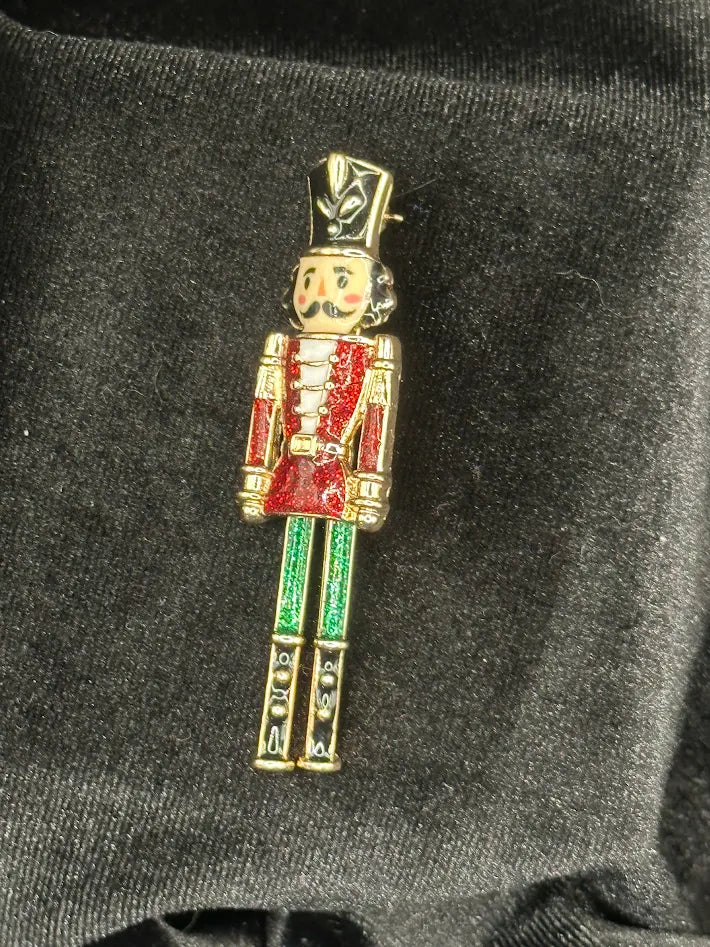 Articulated nutcracker soldier Christmas brooch with red glitter enamel jacket and green trousers, view 2