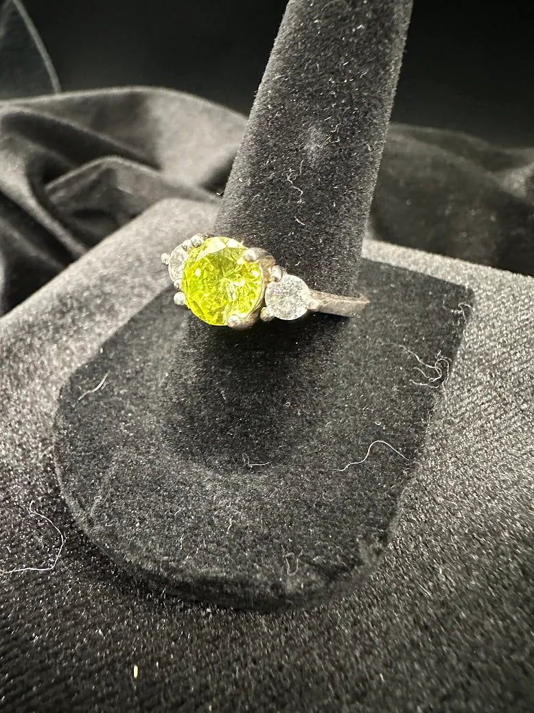 Silver-tone three stone ring with round lime green center and clear side stones, size 6.75, view 3